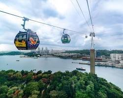 Cable cars suspended above the harbor connecting Singapore mainland to Sentosa