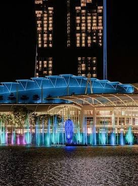 Illuminated water fountains and laser show in Marina Bay at night